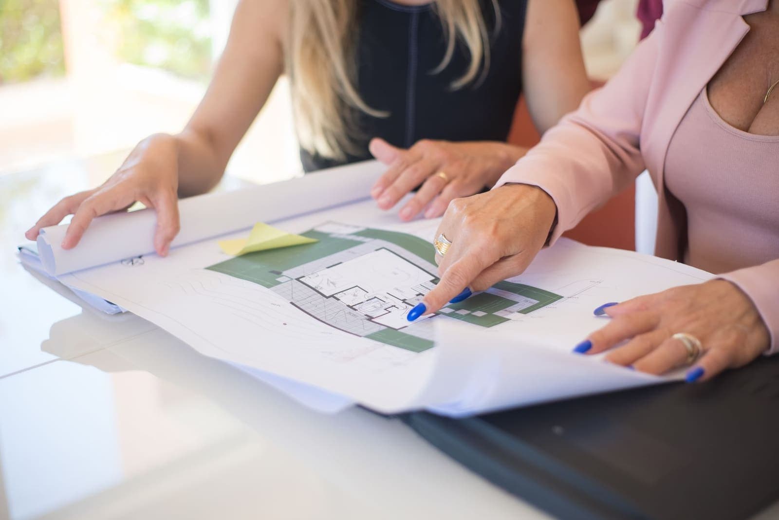 Two people sitting together at a laptop, collaborating on a shared planning board