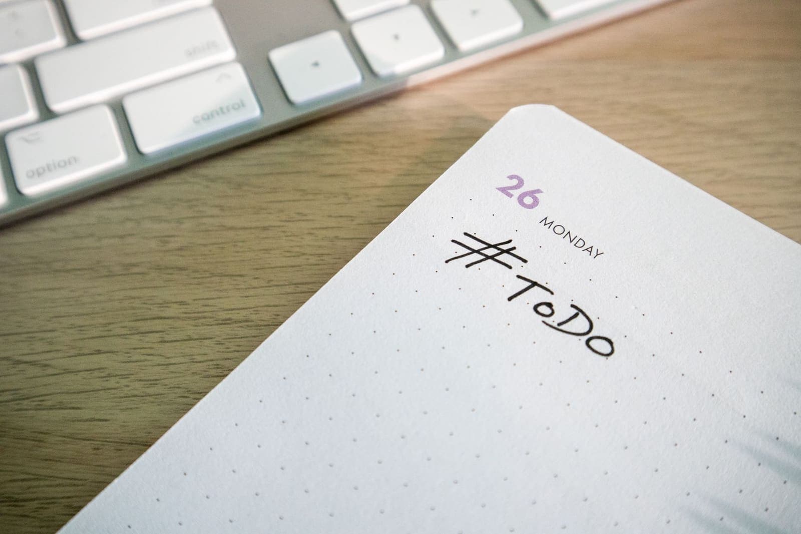 A wall calendar and a handwritten to-do list side by side on a desk